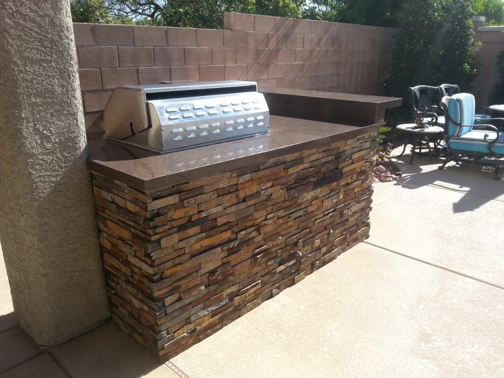 Stacked-stone BBQ island with built-in stainless grill in Las Vegas