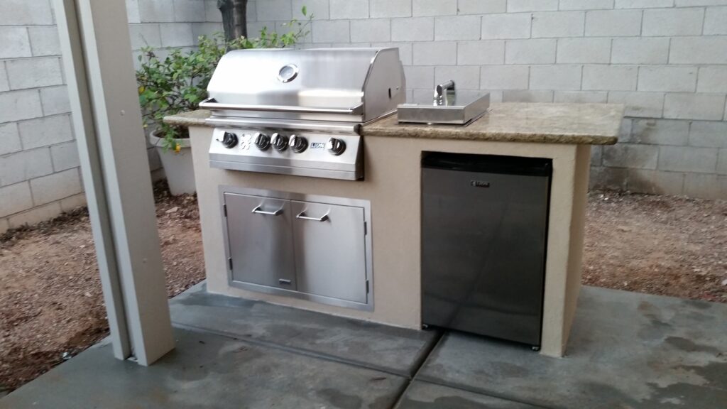 Built-in grill island with stainless doors installed in a Las Vegas backyard