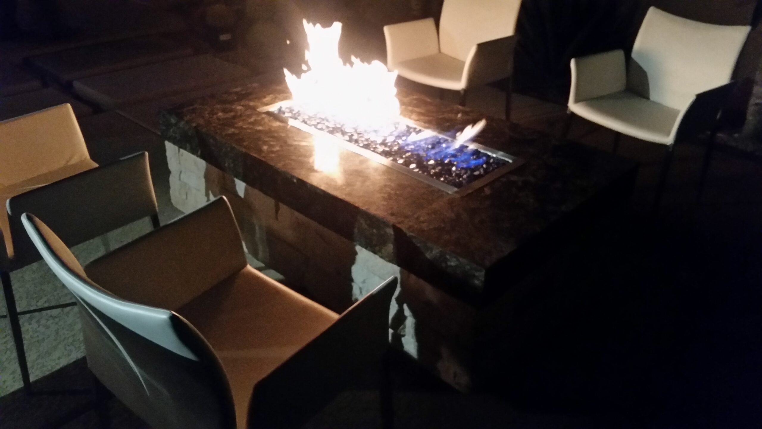 Fire feature glowing at night in a Las Vegas entertaining backyard
