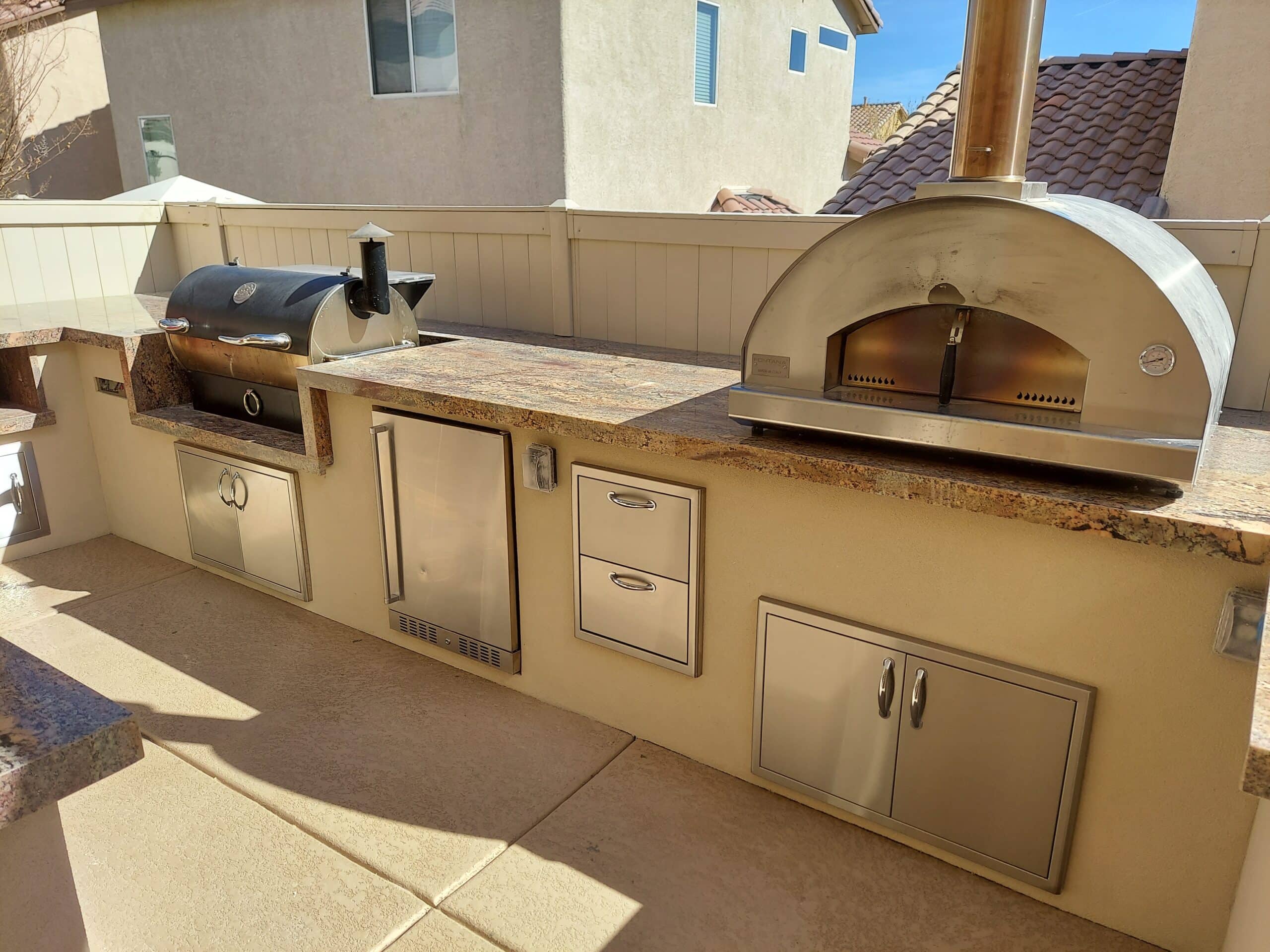 Outdoor kitchen island with built-in pizza oven in Las Vegas