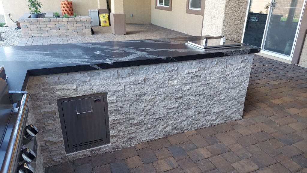 Custom stacked-stone BBQ island with built-in grill in Las Vegas