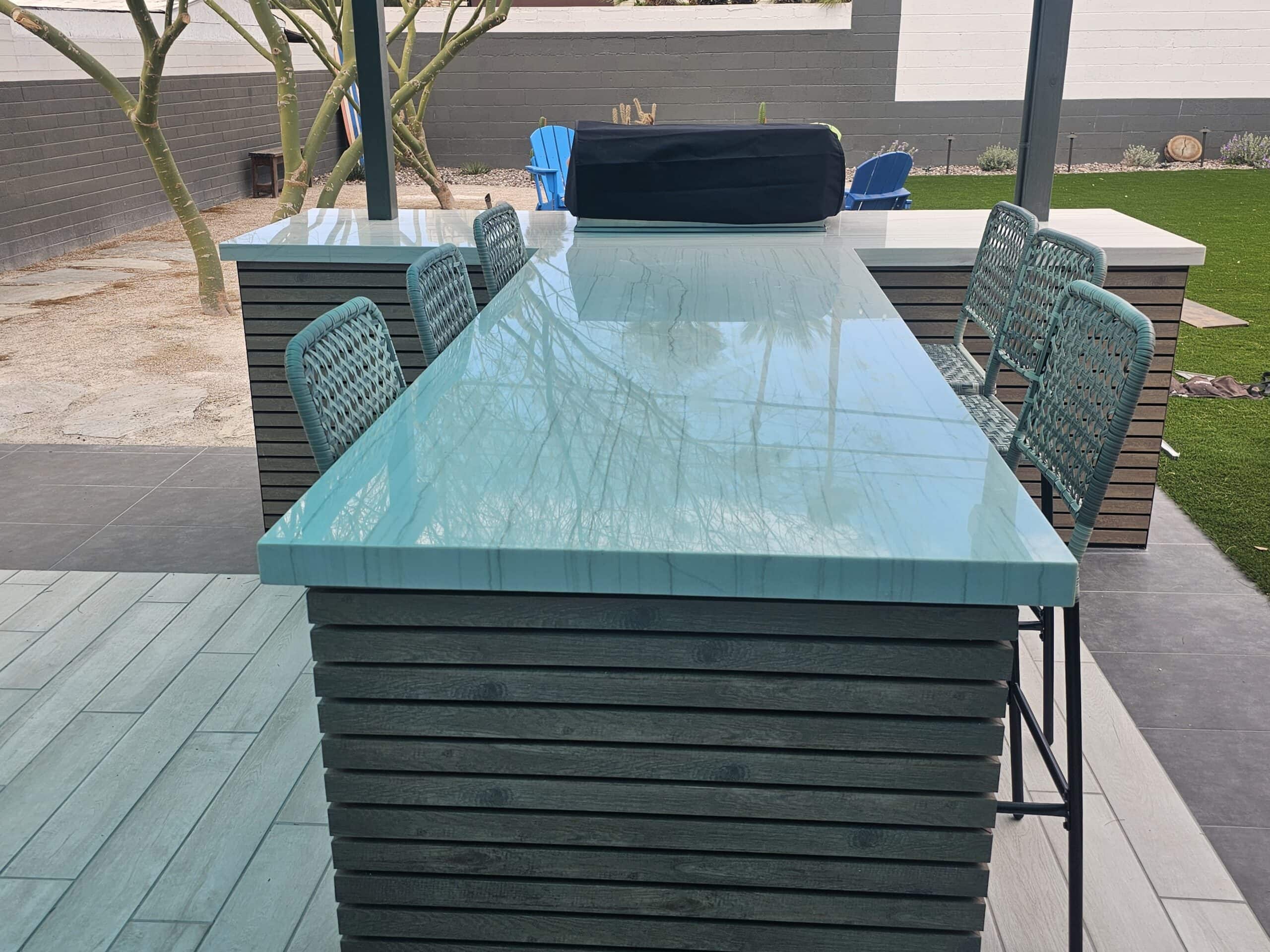 Quartzite countertop and aluminum wood siding detail on a custom T-shaped BBQ island in Las Vegas