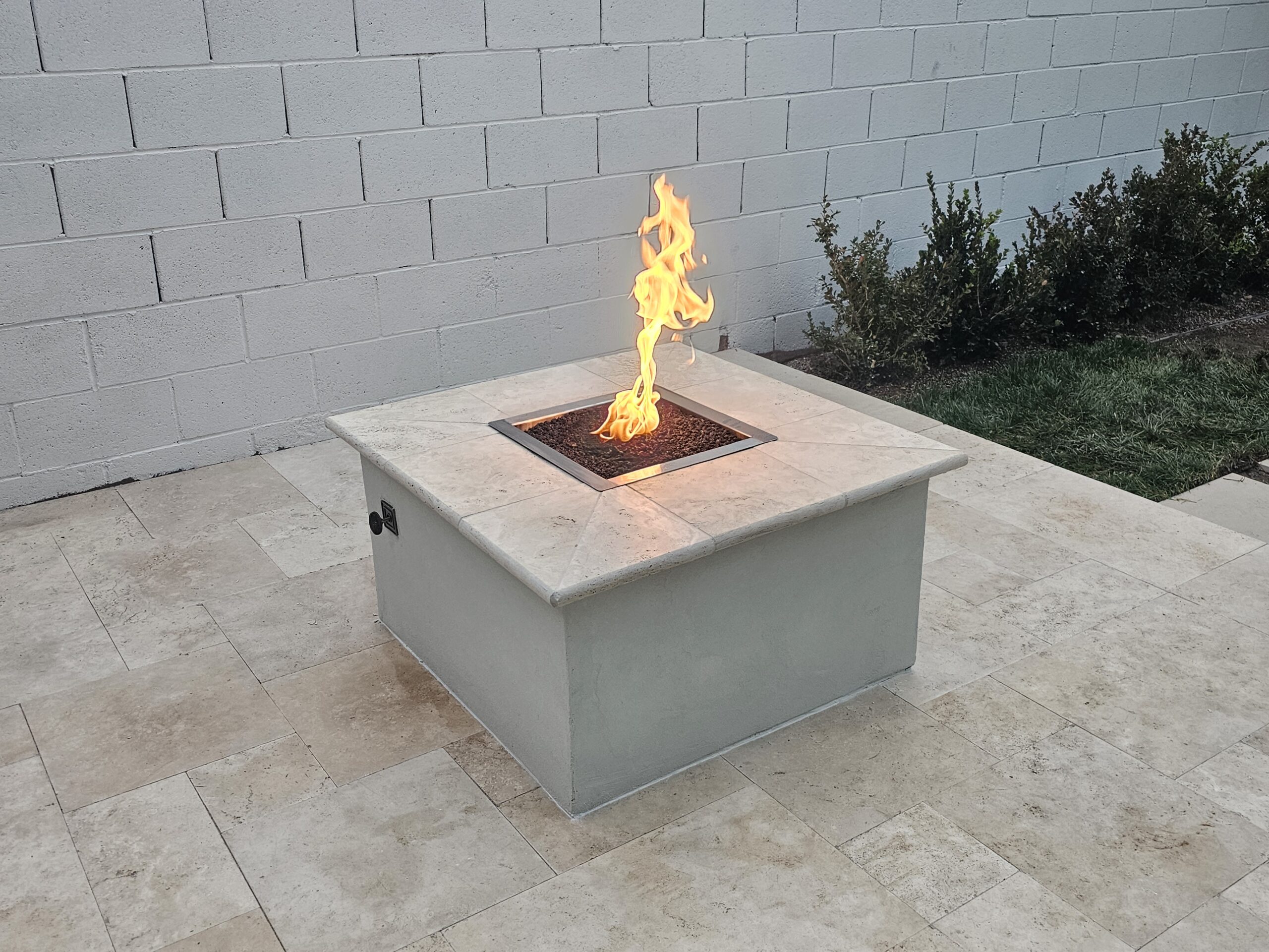 Modern square concrete fire table in a Las Vegas backyard