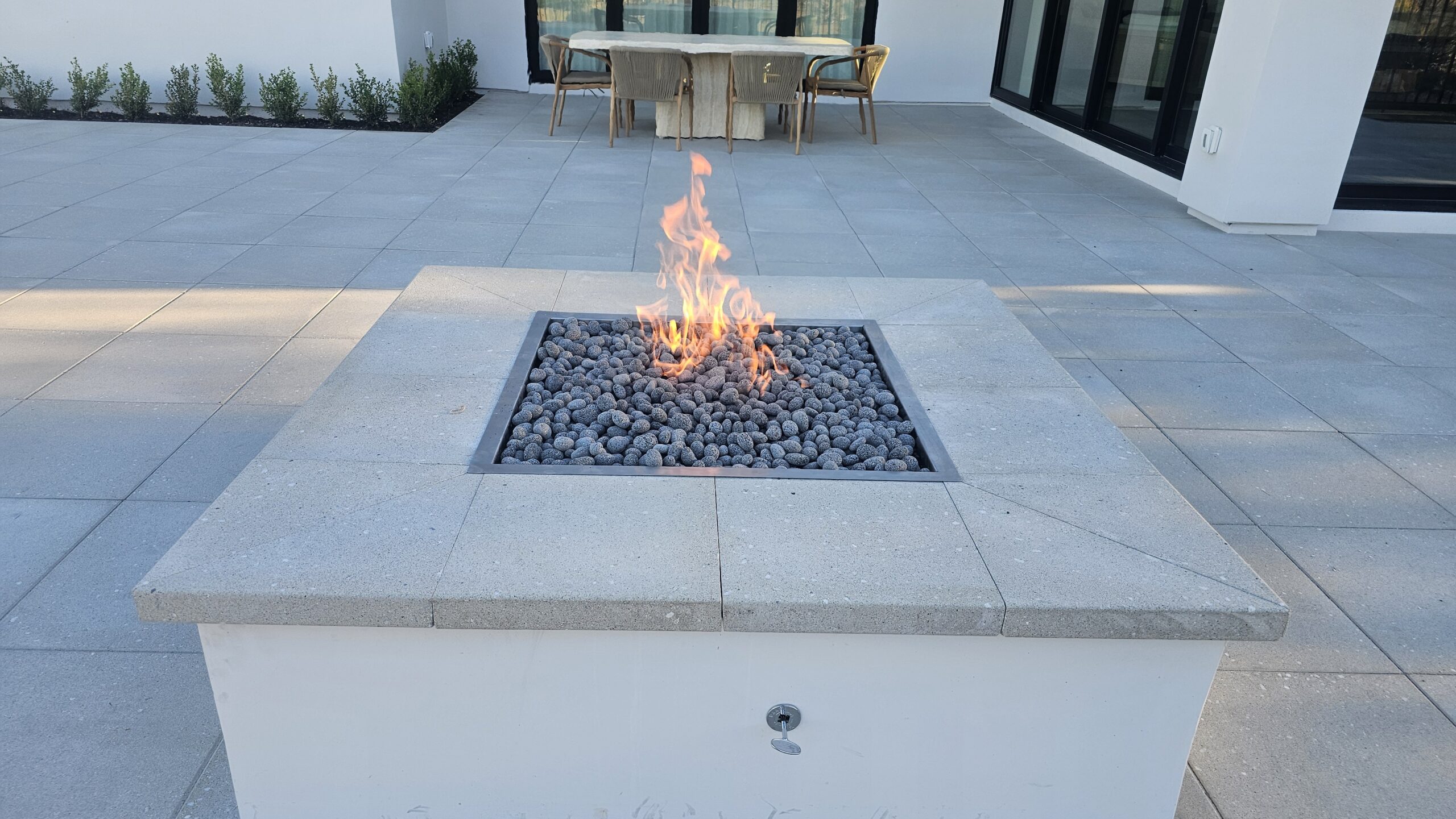 Built-in fire pit with fire glass on a Las Vegas paver patio