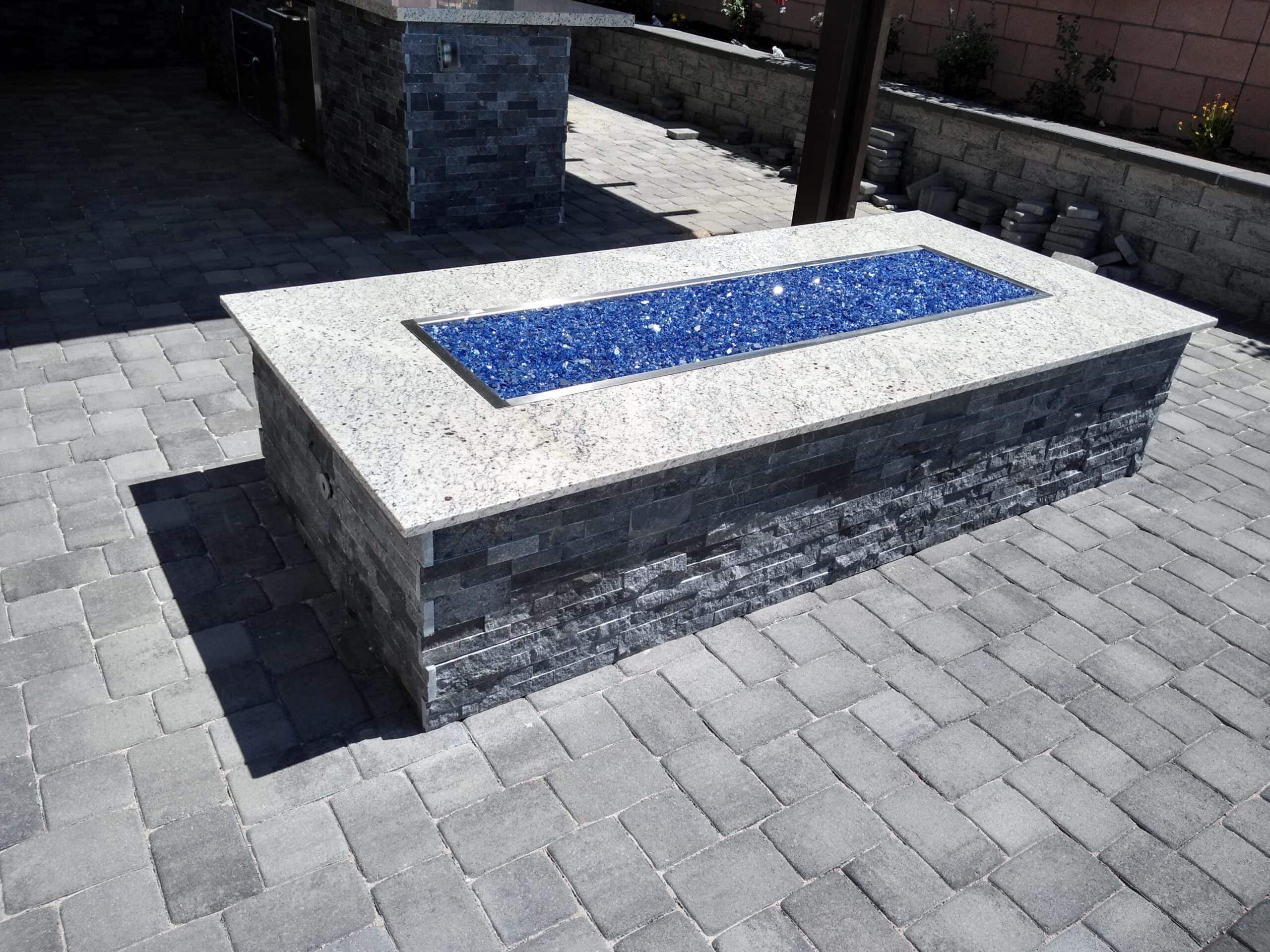 Rectangular fire table with blue fire glass in a Las Vegas backyard