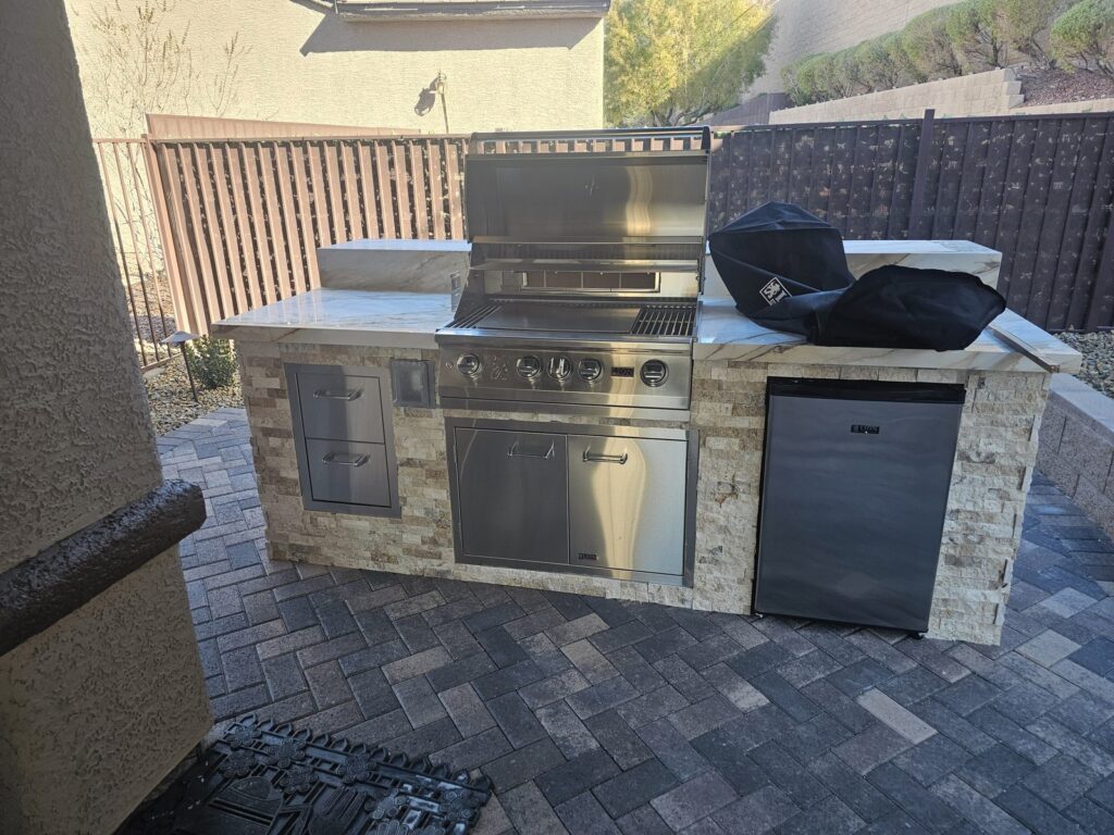 Custom 7-foot BBQ island with travertine ledger stone and Lion grill in Sun City Anthem, Henderson