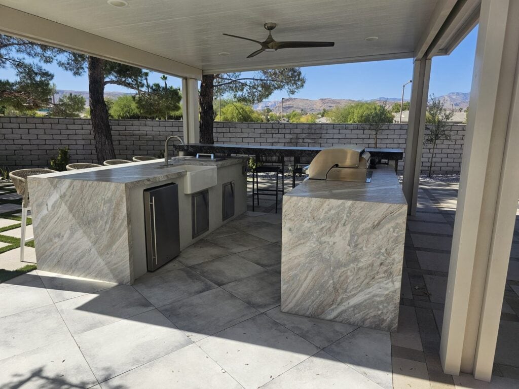 Quartzite outdoor kitchen island with farmhouse sink and drop-in cooler near Summerlin, Las Vegas