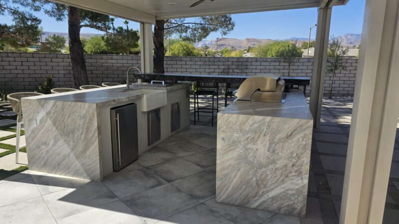 Quartzite Outdoor Kitchen with Suspended Bridge Bar Near Summerlin — Built Around the Homeowner’s Grill