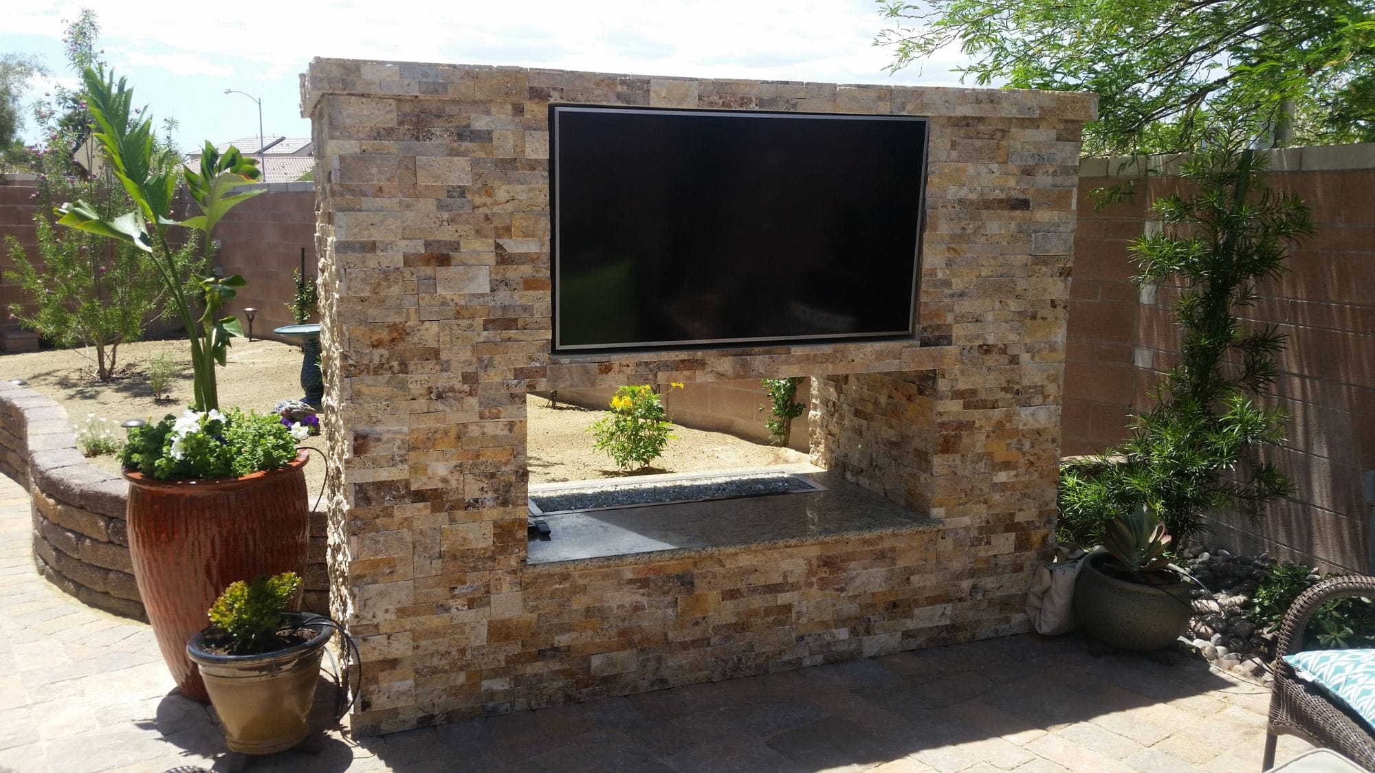 Freestanding stacked-stone outdoor TV media wall in a Las Vegas backyard